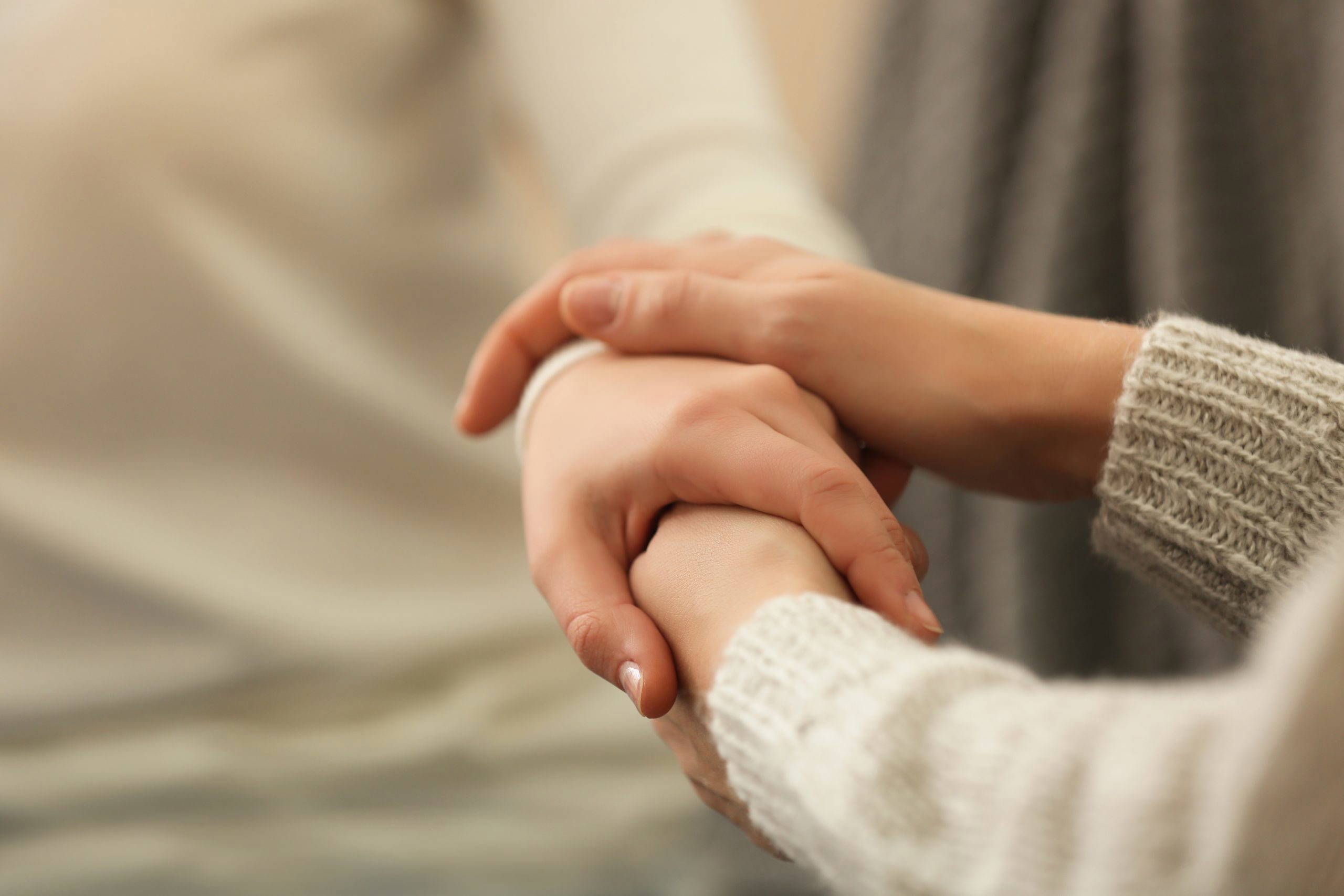 Hands of young woman countenancing depressed friend, closeup